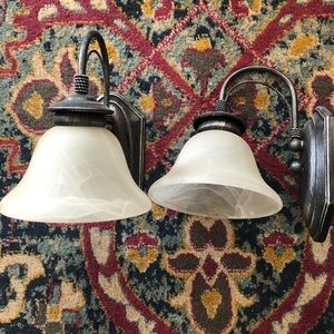Set of 2 pewter-finish wall sconces with frosted swirl glass shades. Hardwire.